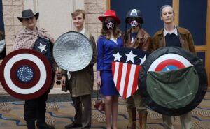  a group of cosplayers portray various versions of Captain America