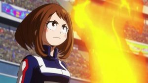 Ochaco Uraaka stands tall looking determined with fire in the background