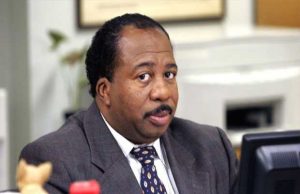 Paper salesman Stanley Hudson glances to his right while working